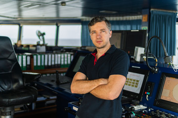 Marine navigational officer during navigational watch on Bridge . Work at sea