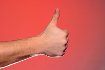 Close-up of a hand with a fingernail up of an isolated on a red background