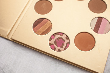 gold palette with bronzer for makeup. beauty and fashion concept