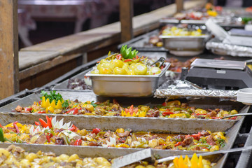 Traditional Hungarian pig slaughter dishes. Street food festival, food service. Fried pork with vegetables