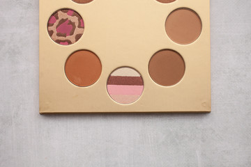 gold palette with bronzer for makeup. beauty and fashion concept