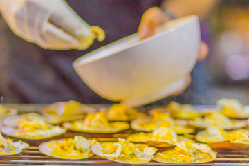 Fresh grilled scallops in scallop shells with chili, butter, garlic, cheese and spinach. Baked scallops with butter scallop shell for sale at the seafood market.