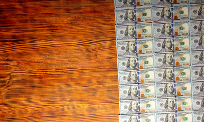 American dollars bills on wooden background. Top view, copy space close up