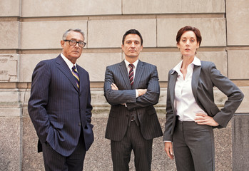 Portrait of three businesspeople in city 