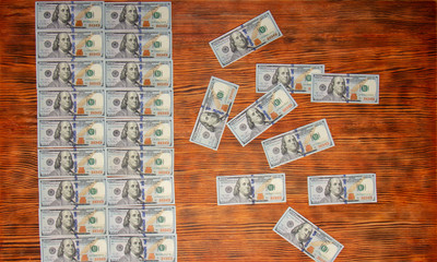 American dollars bills on wooden background. Top view, copy space close up