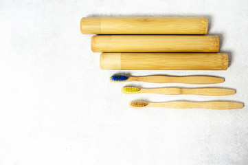 A family set of wooden bamboo toothbrushes on white background