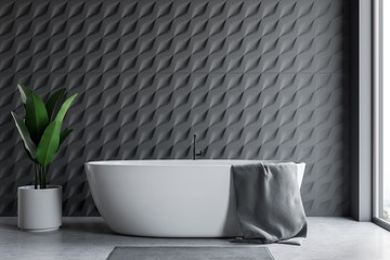 Gray tiled bathroom interior with tub