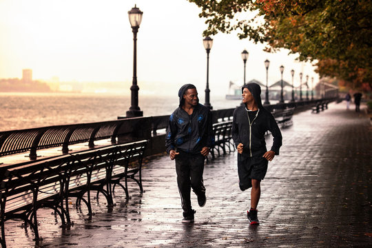 Two men running on promenade 