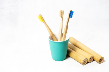 A family set of wooden bamboo toothbrushes on white background