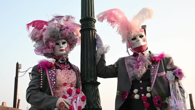 Venice - carnival masks are photographed with tourists in Piazza San Marco