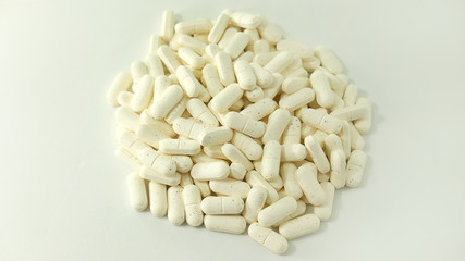 Pile of collagen supplements isolated on white background alternative protein treatment for beauty from within based on capsule consumption for help or maintenance of skin, bones and ligaments healthy