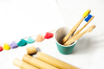 A family set of wooden bamboo toothbrushes on white background