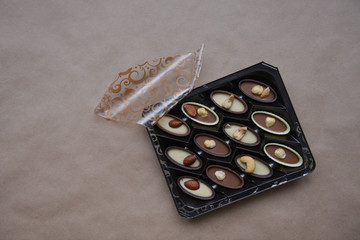 box of chocolates on kraft paper background, festive food, sweet romantic gift, confectionery