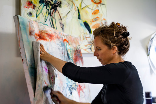 Female artist working on canvas 