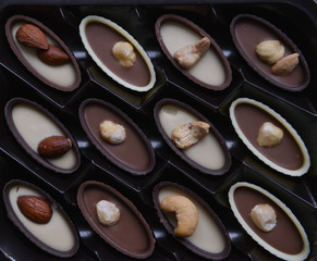 box of chocolates on kraft paper background, festive food, sweet romantic gift, confectionery texture rhythm