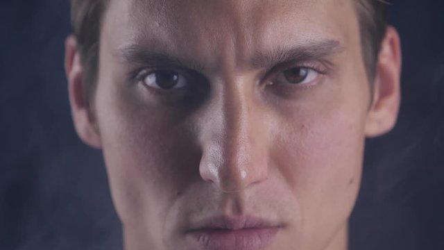 Focused glance. Male looks at camera isolate. Man looks handsome and cool. Guy concentrated focused looking forward. Closeup