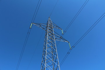 Mighty tall power line utility pole made of strong metal pipes with multiple electrical wires...