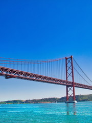 Fototapeta premium Lisbon, Portugal-October 17, 2017: Landmark suspension 25 of April bridge over Tagus River in Lisbon