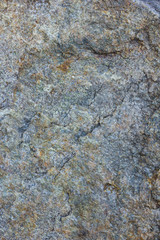 Granite texture close up. Granite rocks with porous surface. Background from solid stone. Pattern with natural material