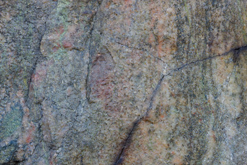 Granite texture close up. Granite rocks with porous surface. Background from solid stone. Pattern with natural material