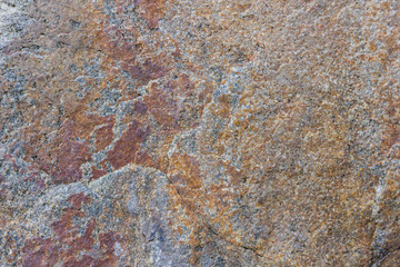 Granite texture close up. Granite rocks with porous surface. Background from solid stone. Pattern with natural material
