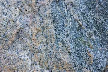 Granite texture close up. Granite rocks with porous surface. Background from solid stone. Pattern with natural material