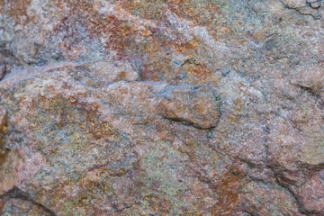 Granite texture close up. Granite rocks with porous surface. Background from solid stone. Pattern with natural material