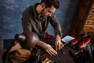hardworking man using craft tool at work. close up photo