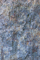 Granite texture close up. Granite rocks with porous surface. Background from solid stone. Pattern with natural material
