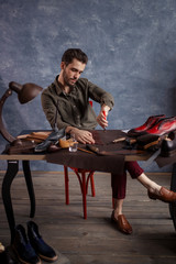 talented cobber cutting the leather for new footwear. full length photo
