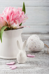 Fresh flowers in jug and Easter eggs
