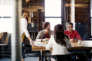 Team working in office refreshments on table 