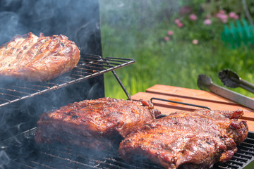Grilled pork ribs on the grill. Summer outdoor