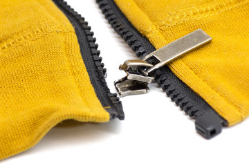 Broken zipper on yellow shirt jacket. Detail close-up photo © axivan.com