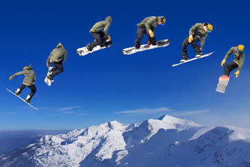 Naklejka na ściany i meble Snowboarding Snowboard Snowboarder at jump mountains at sunny day