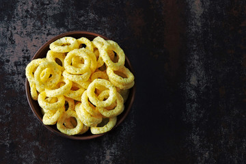 Corn rings in a bowl. Onion rings in a bowl.