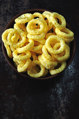 Corn rings in a bowl. Onion rings in a bowl.