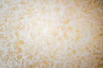 New cooked white jasmine rice in the electric rice cooker pot background.