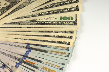 Bundle of hundred dollar banknotes on a white background