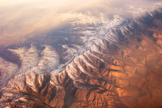 View of rocky mountains from airplane 