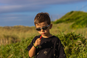 kid with candy and sunglasses