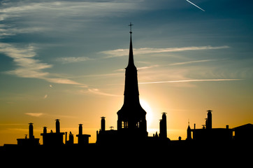 Horizontal landscape, evening silhouette of Szczecin city with catholic church in orange sunset