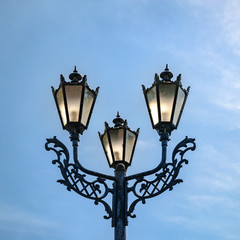 Fototapeta na wymiar Vintage street lamp against a blue sky.