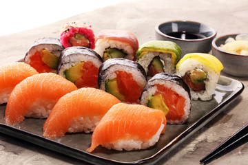 close up of sashimi sushi set with chopsticks and soy - sushi roll with salmon and sushi roll with smoked eel