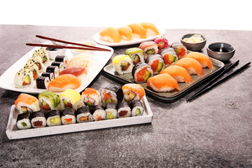 close up of sashimi sushi set with chopsticks and soy - sushi roll with salmon and sushi roll with smoked eel