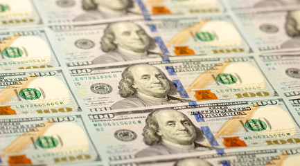 Blurred background full of 100 us dollars. Business and finance. selective focus.