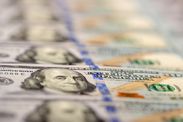 Blurred background full of 100 us dollars. Business and finance. selective focus.