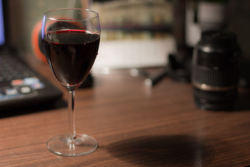 A glass of wine on the desk