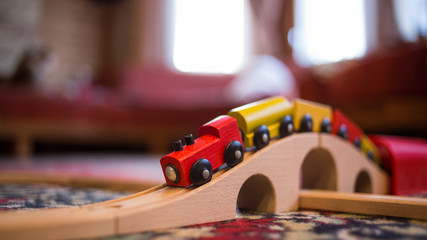toy wooden train and railway on the carpet in the child's room