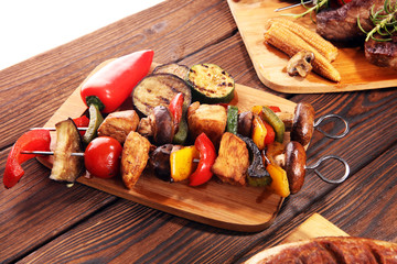 Assorted delicious grilled meat with vegetable on rustic table